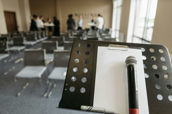 Microphone on a stand in an empty conference room, representing professions as dealbreakers in relationships.