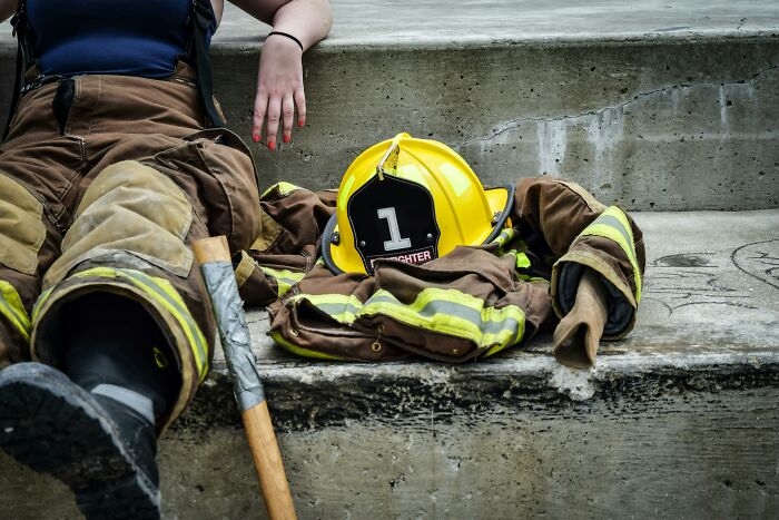 Firefighter gear and helmet on concrete steps, showcasing a profession as a potential relationship dealbreaker.