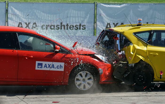 Two cars in a crash test impact, illustrating unexpected escalation of events.