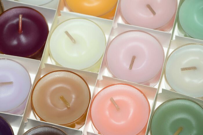 Colorful candles arranged neatly, demonstrating a frugal home hack for affordable luxury décor.