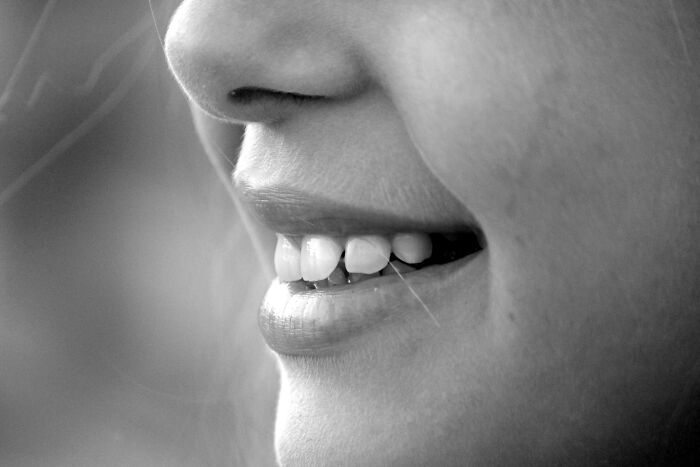 Close-up of a person's smiling mouth, showcasing teeth and lips, illustrating a detail related to everyday facts.