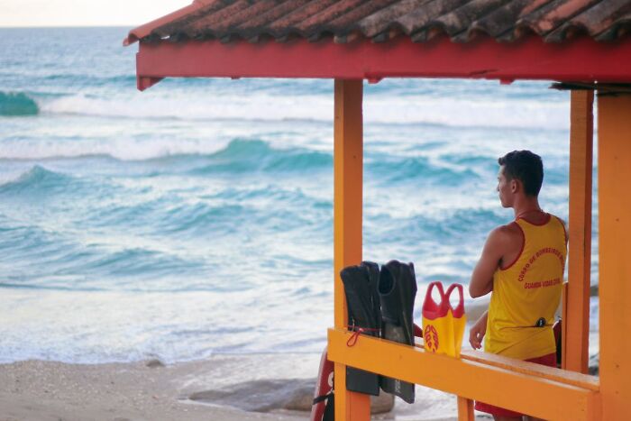 Lifeguard on duty overlooking the ocean, representing job secrets common people aren't supposed to know.