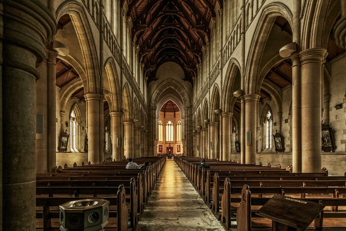 A solitary figure in an empty church, illustrating the concept of friends becoming strangers.