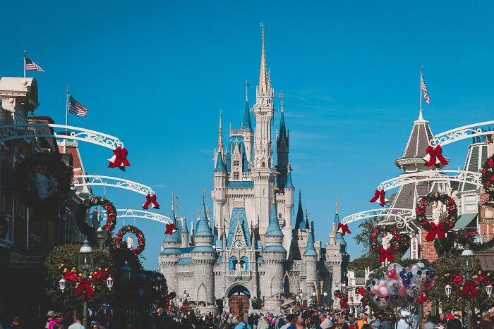 Disneyland castle with crowds, showcasing a historical influence moment.