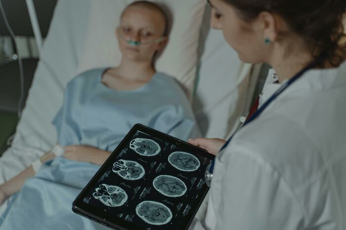 Medical professional reviewing brain scans with patient, sharing important information.