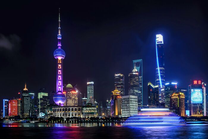 Shanghai skyline at night with bright skyscrapers, showcasing rare everyday facts about urban illumination.