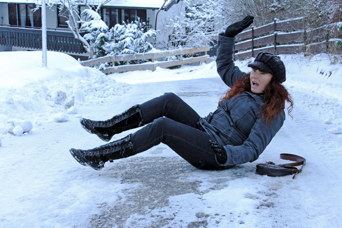 Person slipping on icy sidewalk, illustrating frustration when neighbors don\'t shovel snow.