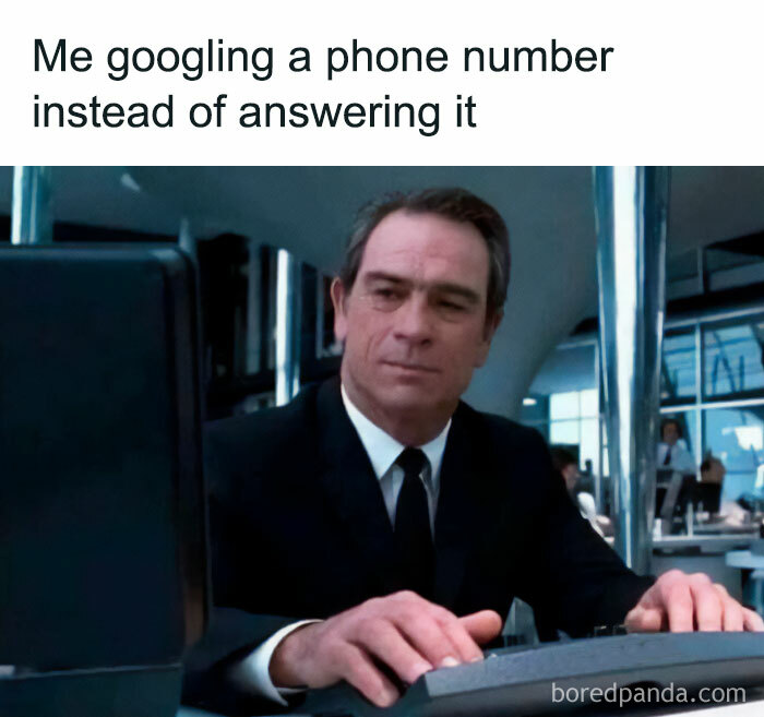 Man humorously googling a phone number at a computer, portraying relatable unhinged memes.