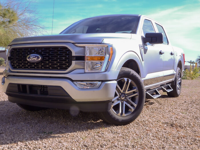 Silver Ford truck parked on gravel, a retirement gift purchase.