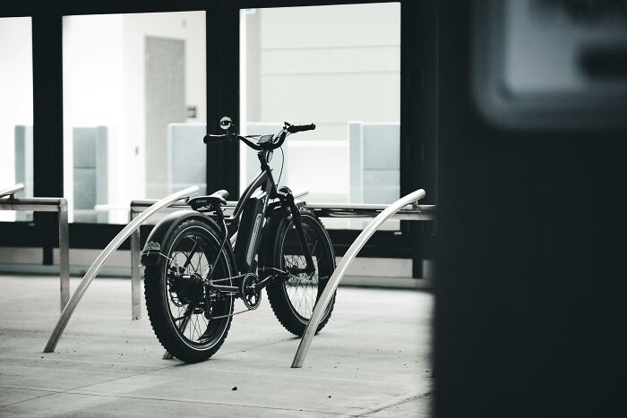 Electric bike parked at a bike rack, a popular gift for retirees enjoying new hobbies and adventures.