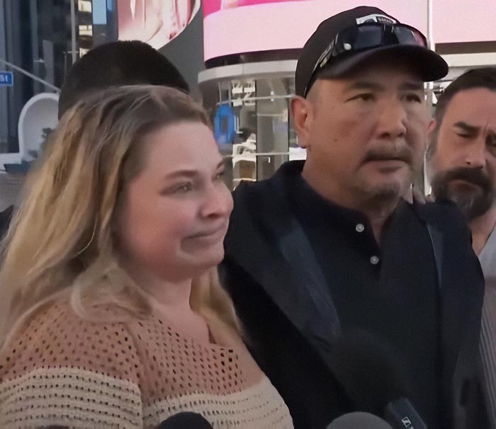 A woman standing with a man in an outdoor setting, focusing on her healing journey.