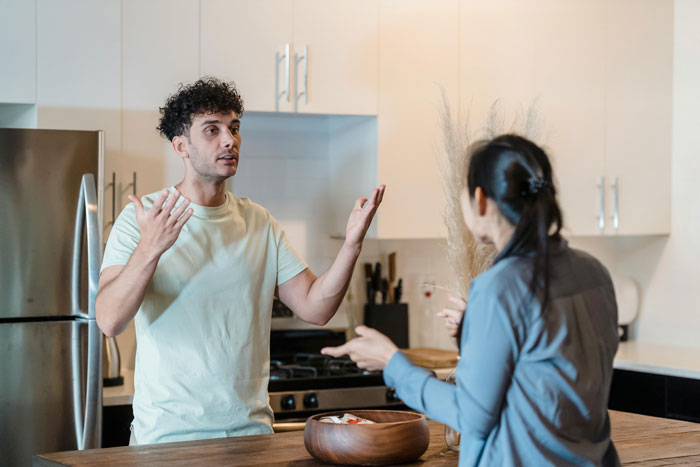 Couple arguing in kitchen over mayo consistency.