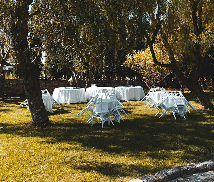 Empty wedding setup in a garden, tables and chairs unset, symbolizing signs of a marriage destined to fail.