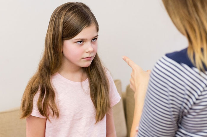 Child receiving a scolding, highlighting signs of terrible parents.