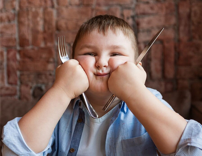 Child holding fork and knife, signs of terrible parenting depicted.