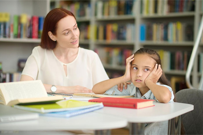 A woman looking at a bored child in a library, highlighting signs of terrible parents.