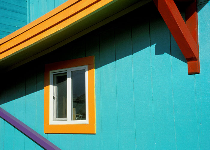 Colorful house exterior with bright accents, expressing homeowner creativity against HOA norms.