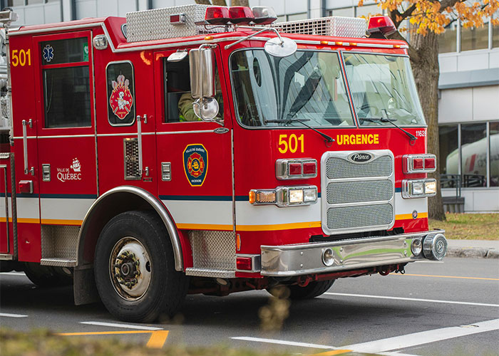 Red fire truck parked in a suburban neighborhood associated with homeowner actions against HOA.