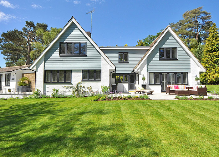 Modern home with a well-kept lawn, representing homeowners standing up to their HOA.