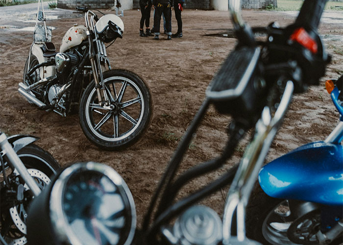 Motorcycles parked under a bridge, symbolizing homeowners defying HOA rules.