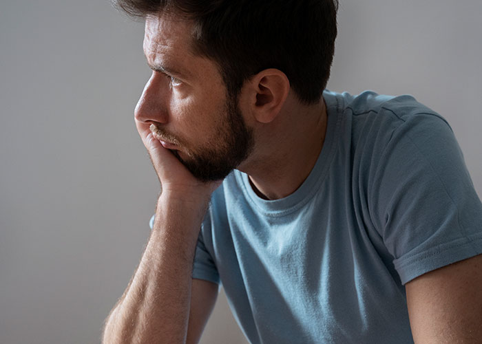 Man in blue shirt looking thoughtful, highlighting marriage discoveries.