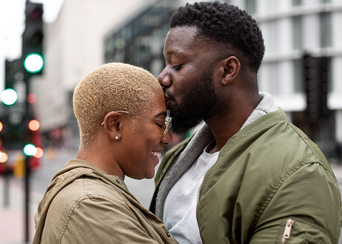 Couple embracing lovingly on a city street, highlighting marriage discoveries.