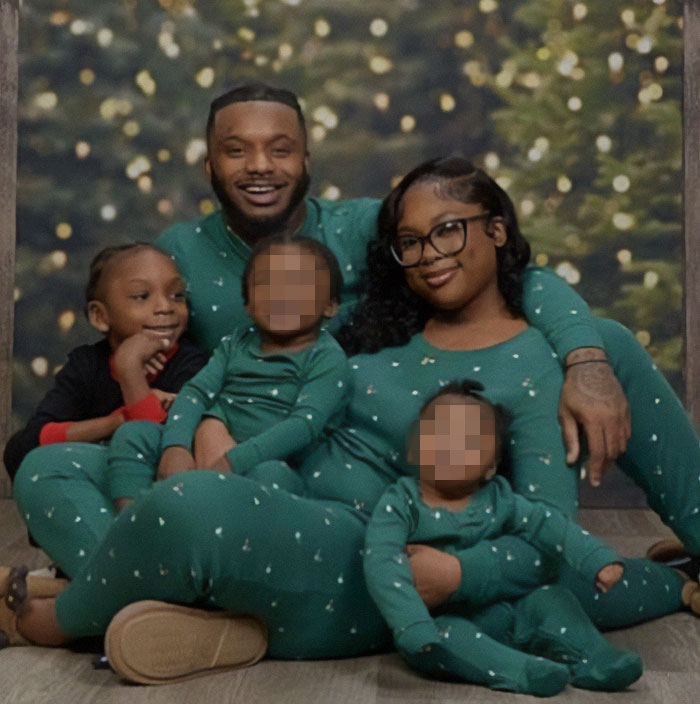 Family in matching pajamas, mother responds to son's different outfit, sparking Christmas photo controversy.