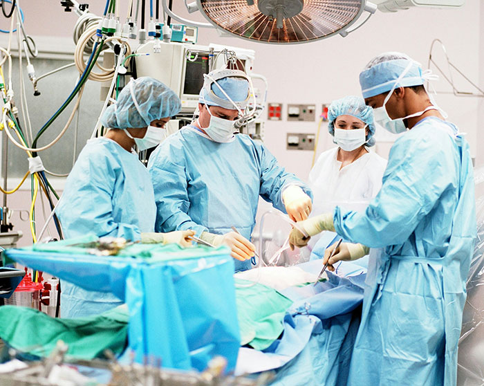 Doctors in an operating room, highlighting issues with insurance claims being denied by UnitedHealthcare.