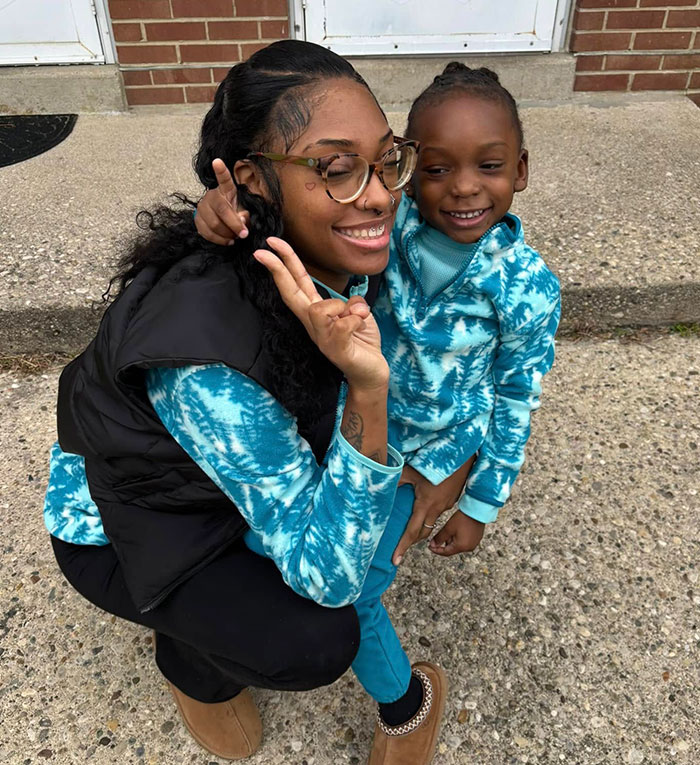 Mother poses with son wearing matching tie-dye outfits, responding to Christmas pyjamas controversy.