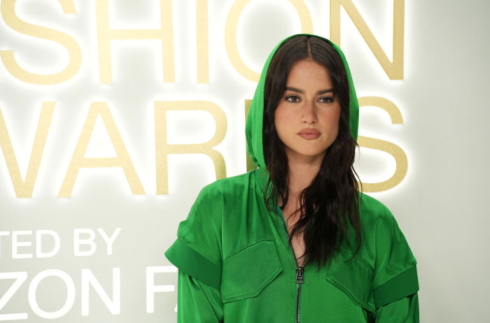 Cast member of Tell Me Lies in a green outfit at a fashion awards event.