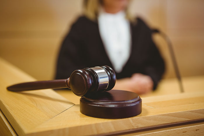 Gavel on a courtroom table, symbolizing a legal victory for tenant assisted by ChatGPT against a landlord.