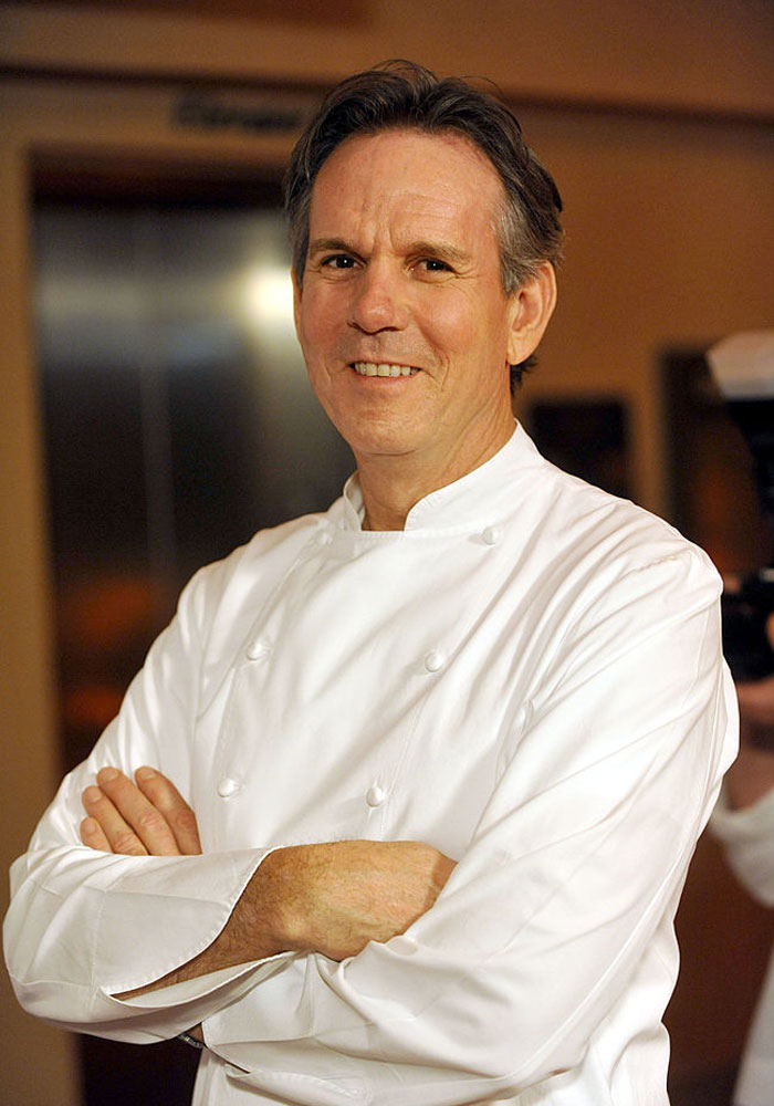 Thomas Keller in white coat, arms crossed, returning star in The Bear season 3 with exciting guest appearances.