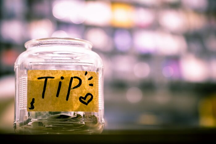 Clear tip jar on a counter, highlighted with a yellow label and doodles, symbolizing altered perception of a partner.