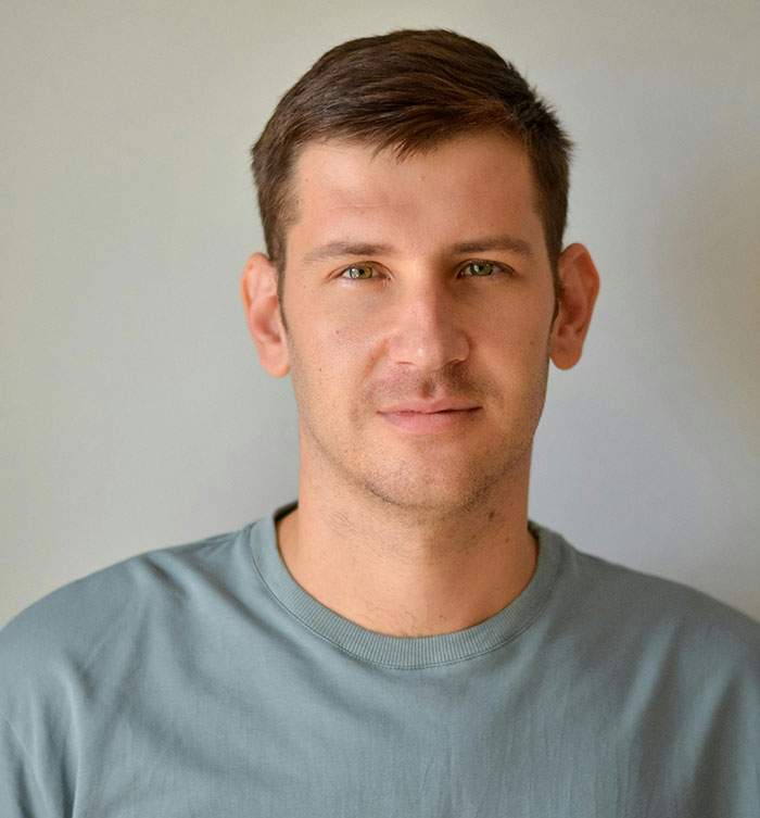 Man with a light blue shirt smiling slightly, representing unique rare statistics theme.