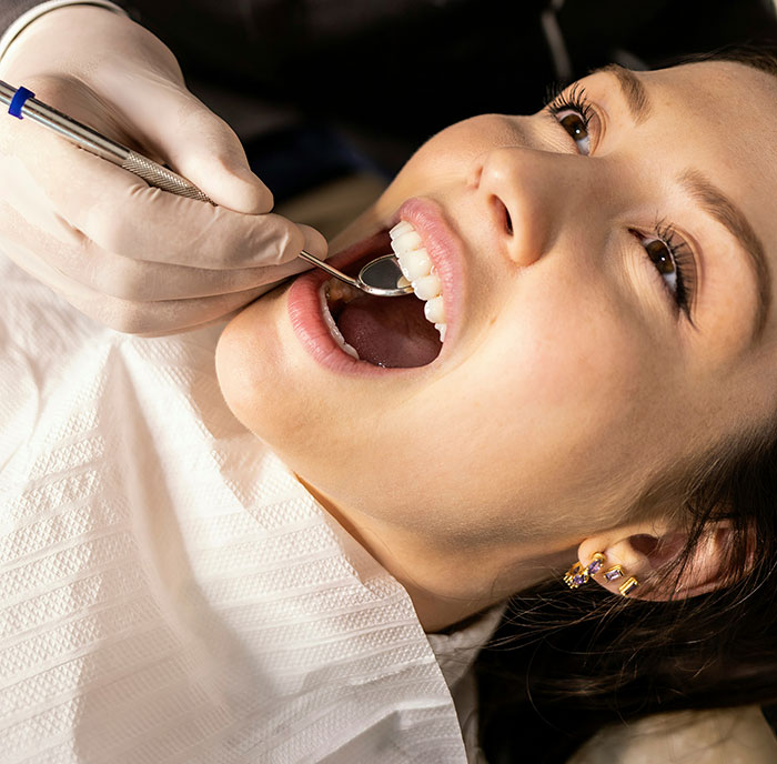 Person in dental chair getting teeth examined, showcasing unique rare statistics in dentistry.