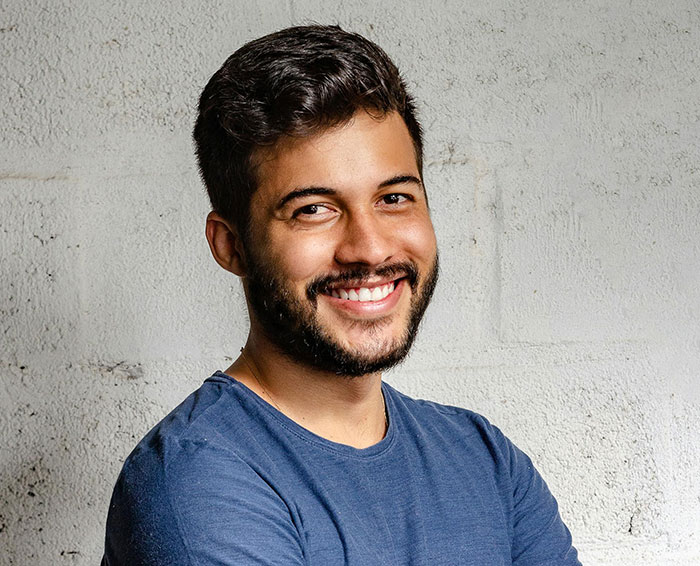 Smiling man in a blue shirt, representing unique rare statistics insights.