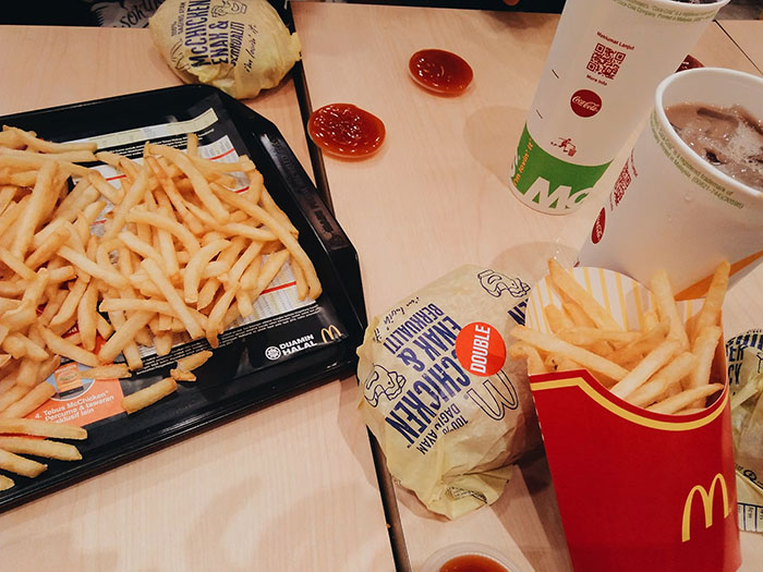 Fast food meal featuring fries and burgers, items often bought by adults denied in childhood.