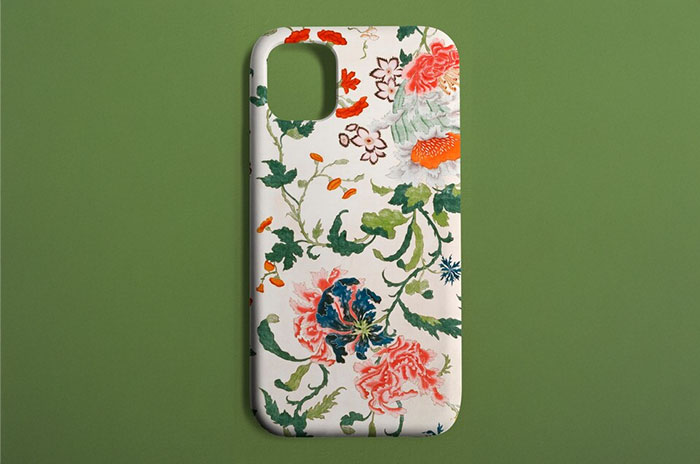 Floral phone case on a green background, a popular buy for adults fulfilling childhood desires.