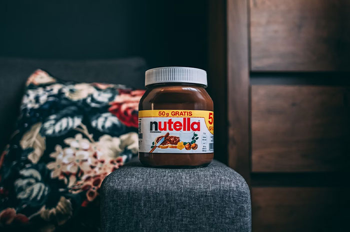 Nutella jar on a chair, symbolizing things people bought as adults after being denied in childhood.