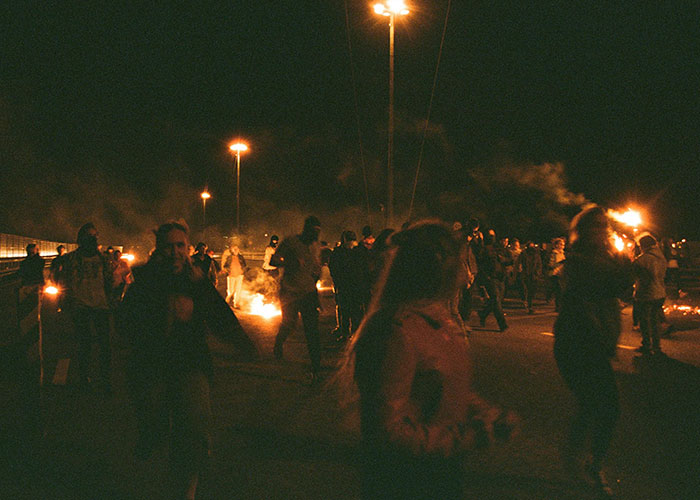 People gathered at night with fire, illustrating things people want but are actually terrible.