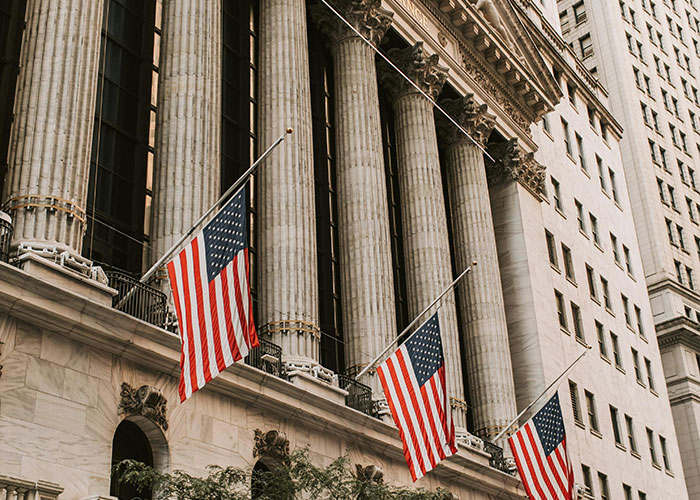 U.S. flags in front of a historic building with columns, symbolizing things-people-want-actually-terrible.