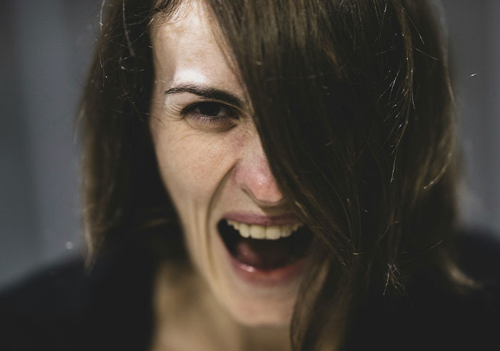 A person's face expressing anger, illustrating toxic family dynamics.