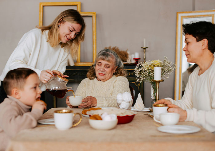 Family having a meal together, highlighting subtle signs of toxic dynamics in a household setting.