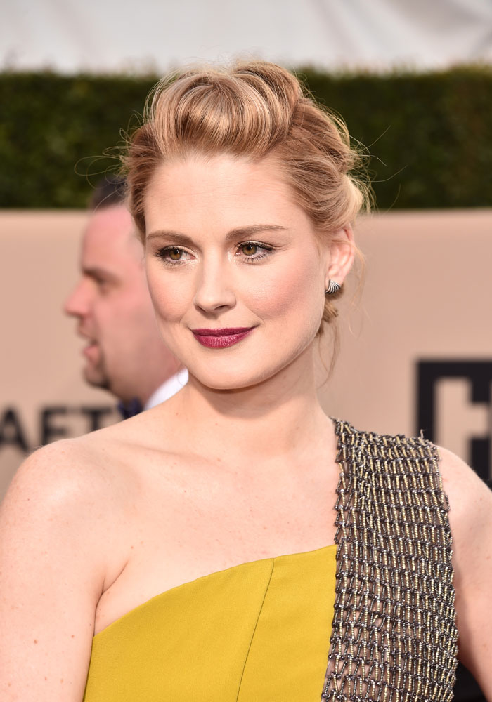 Actor from Virgin River cast at a red carpet event, wearing an elegant one-shoulder dress.