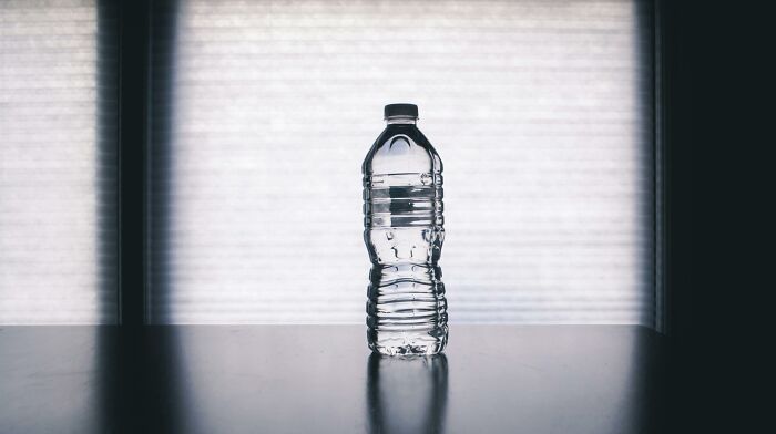 Plastic bottle on a dark surface.