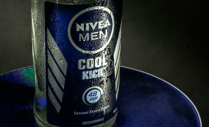 Close-up of a Nivea Men deodorant bottle on a dark background, highlighting the product's design and branding.