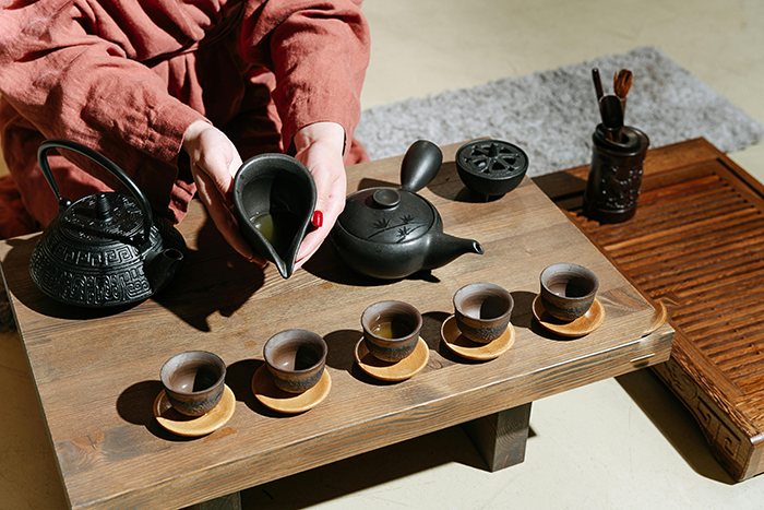 Tea ceremony setup with traditional teaware on a wooden table, showcasing cultural traditions.