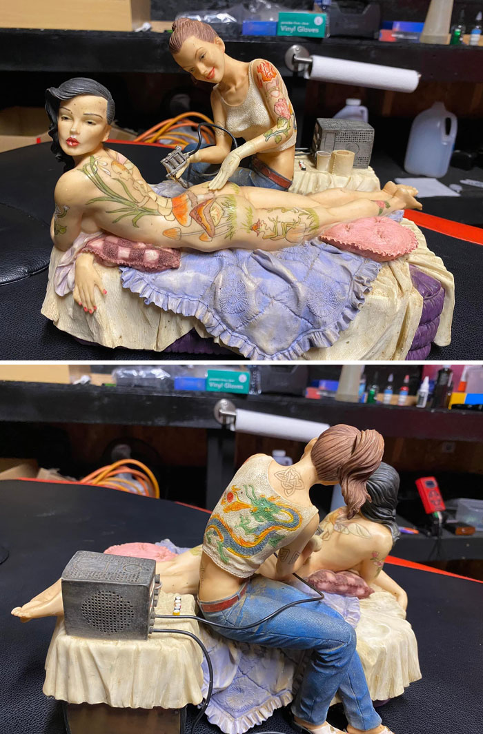 Strange and spectacular second-hand ceramic figures, one tattooing the other on a detailed bed setting.