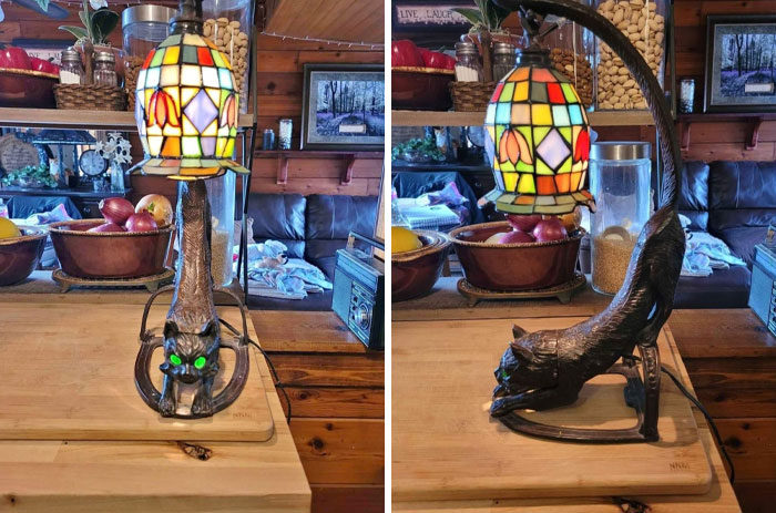 A strange and spectacular stained glass lamp featuring a cat with glowing eyes, creating a unique and colorful ambiance.