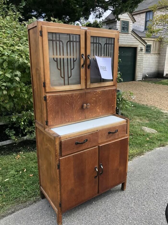 Second-hand vintage cabinet with glass doors and ornate design, found free on the street, showcasing a unique discovery.